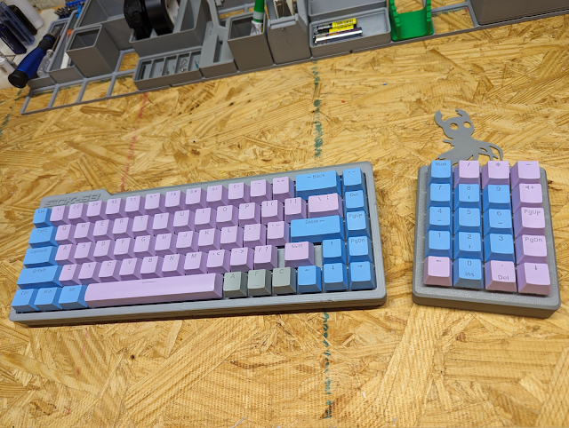 Shoddy looking keyboard that wobbles a bit. Grey with blue and pink keys.